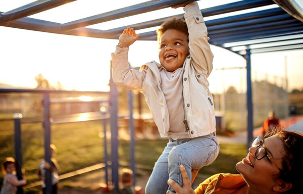 Boy climbing monkey bars